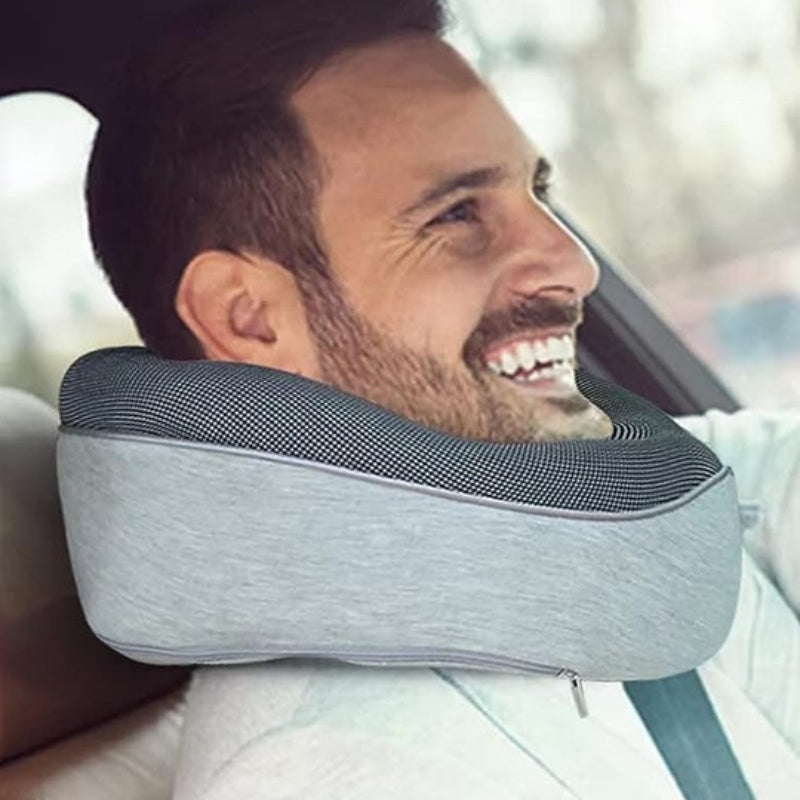 Man using a neck pillow in a car