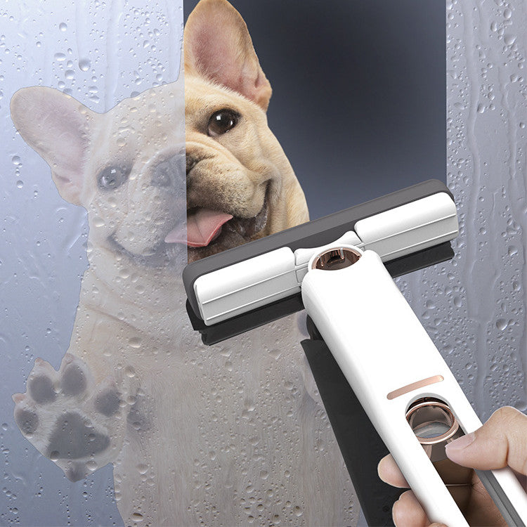 Person cleaning a glass surface with a squeegee, with a dog looking on.