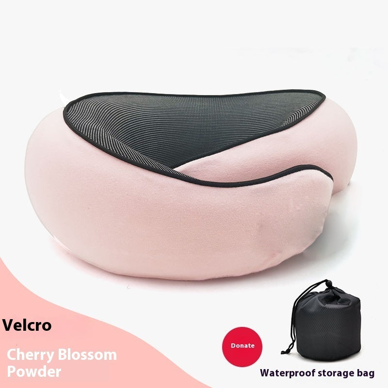 Pink neck pillow with black mesh cover on a white background, accompanied by a black storage bag.
