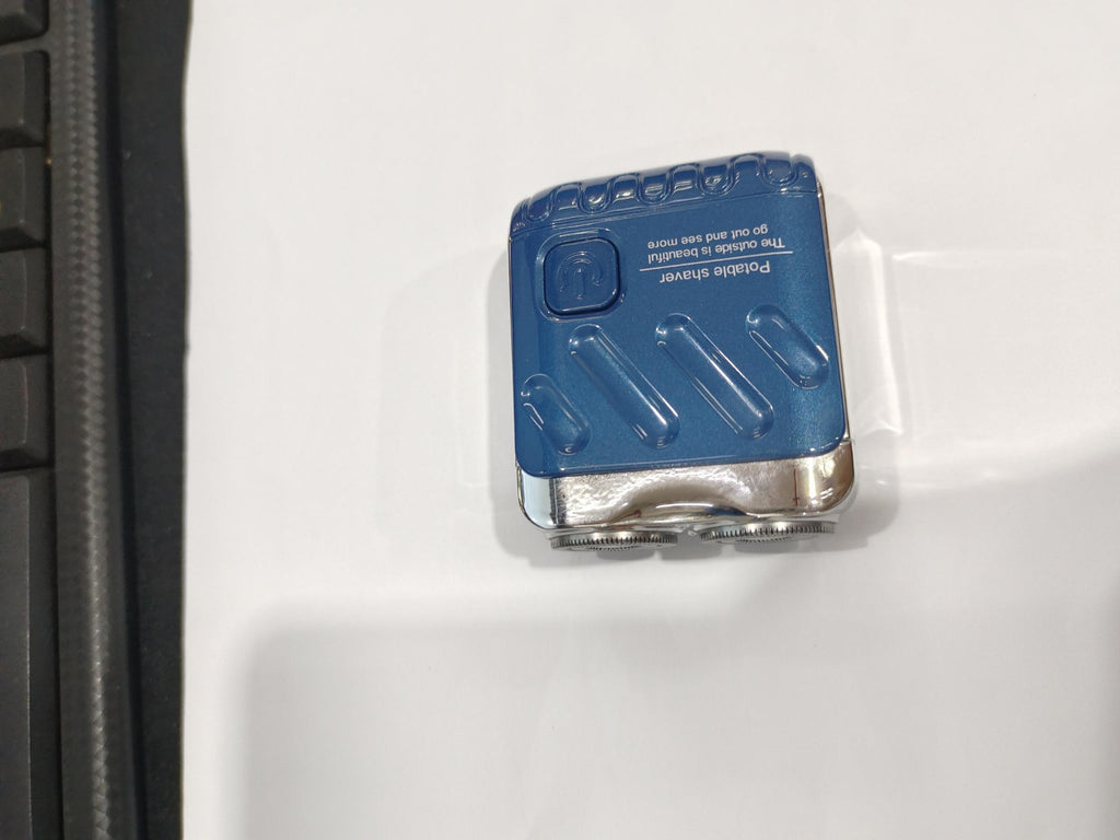 Blue and silver device attached to a white surface