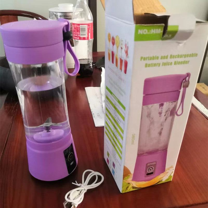 Purple portable blender with charging cable on a table next to its packaging box.