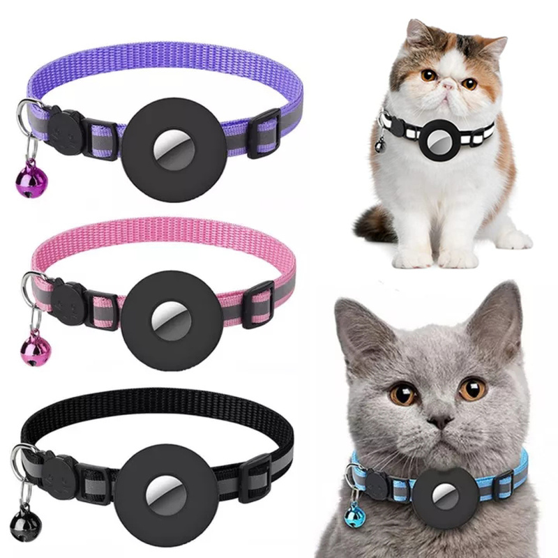 Three pet collars with black circular center pieces and small bells are shown on a white background, alongside two cats wearing similar collars. The collars come in purple, pink, and black versions.