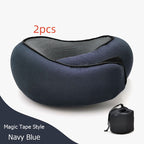 Two navy blue magnetic travel neck pillows with black mesh lining and black tape, shown with a small black drawstring storage pouch on a white background.