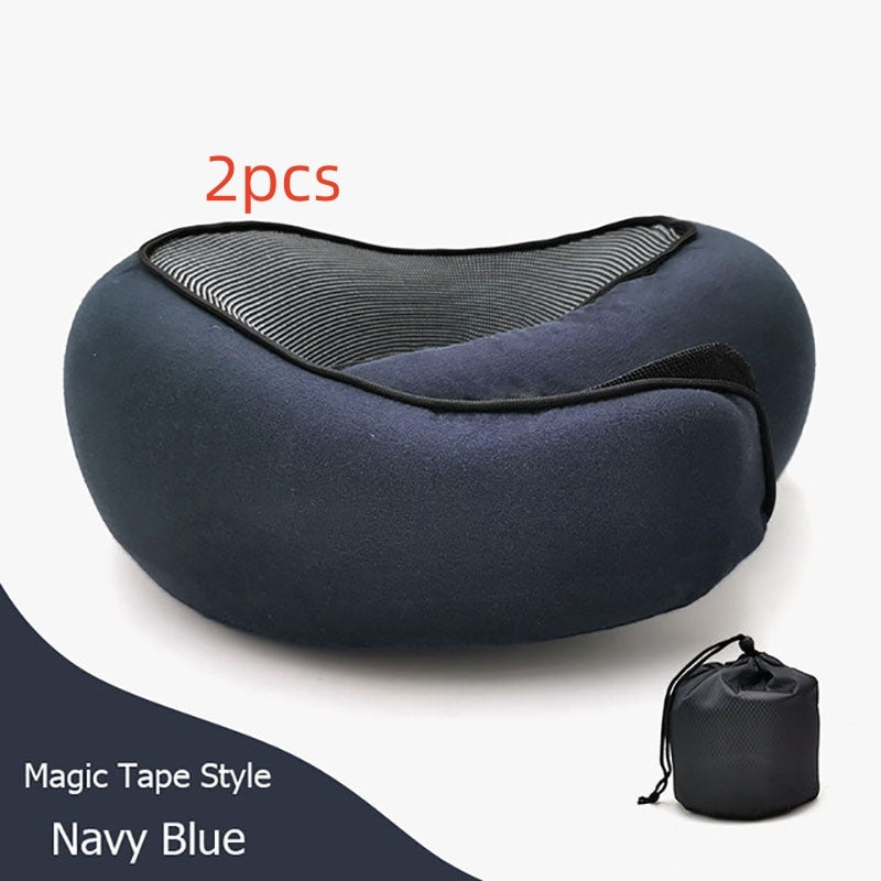 Two navy blue magnetic travel neck pillows with black mesh lining and black tape, shown with a small black drawstring storage pouch on a white background.