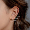 Woman wearing Golden Hoop Magic Earrings for a chic look