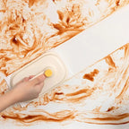 Hand using a handheld device on a marble surface with orange and white patterns