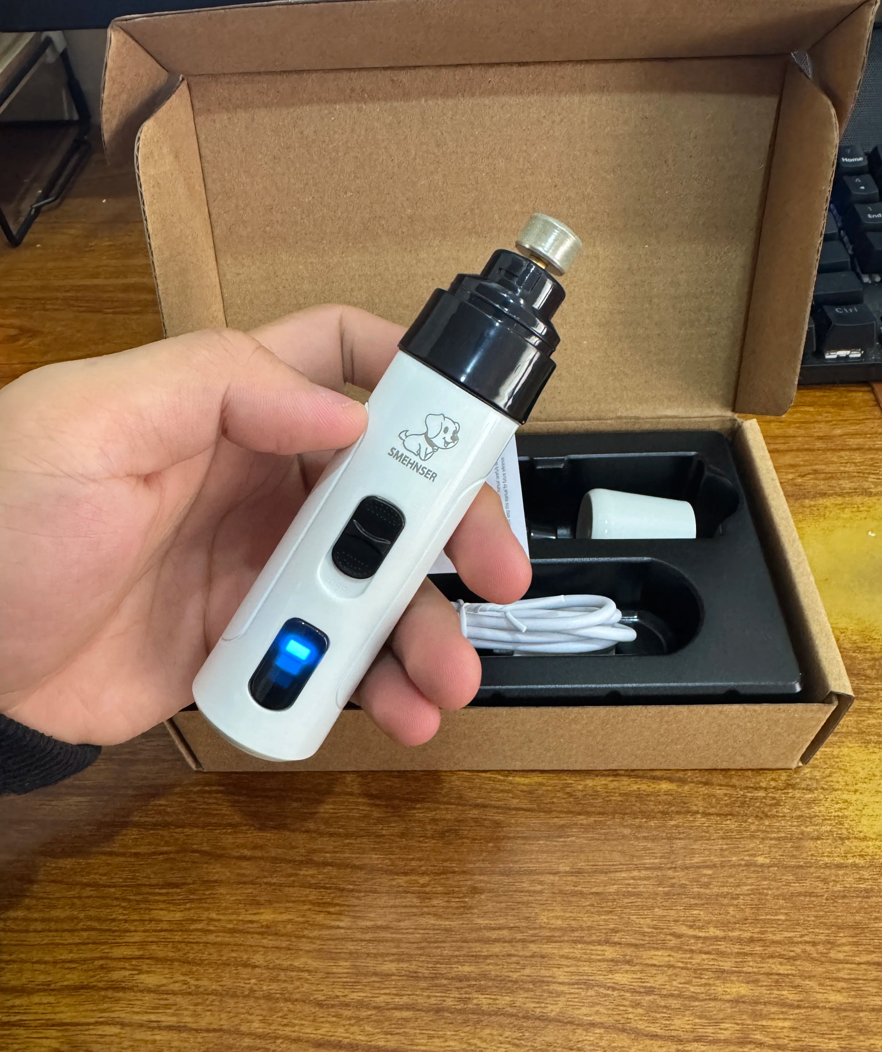 awPerfect electric nail trimmer held comfortably in hand